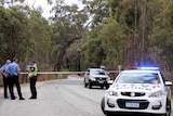 A police road block in bushland.