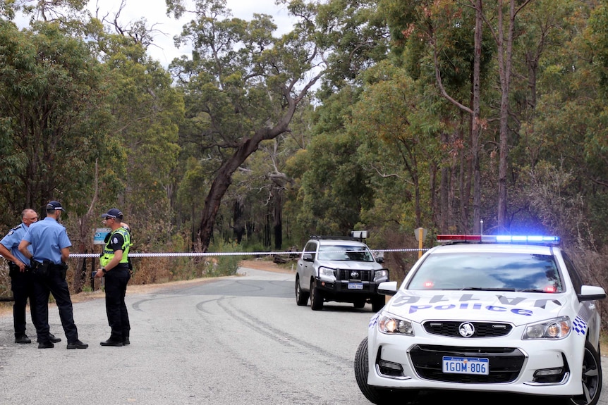 A police road block in bushland.