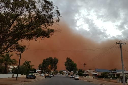 orange clouds of dust above a suburban Broken Hill street