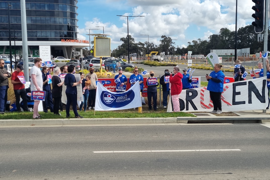 Striking nurses holding banners
