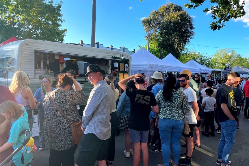 people lined up at a food truck
