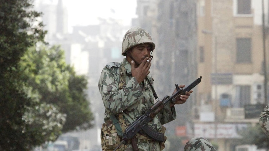 Egyptian soldiers stand on top of tank, surrounded by protesters in Cairo January 29, 2011.