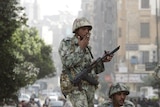 Egyptian soldiers stand on top of tank, surrounded by protesters in Cairo January 29, 2011.