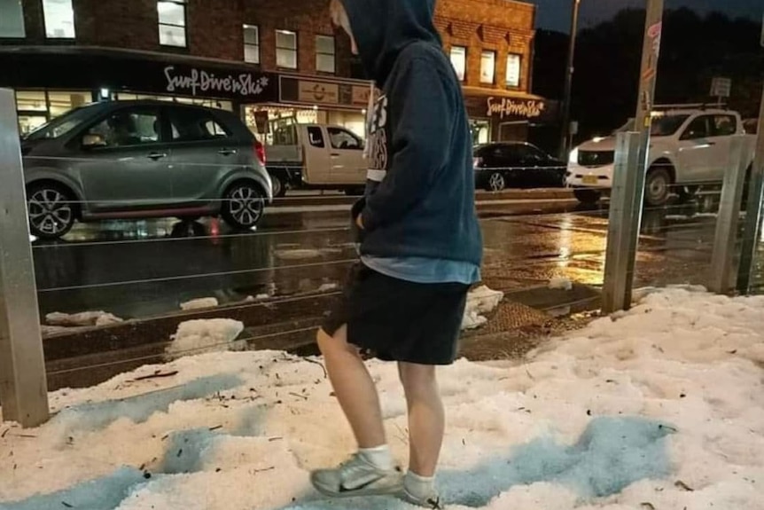 boy walks in  hail