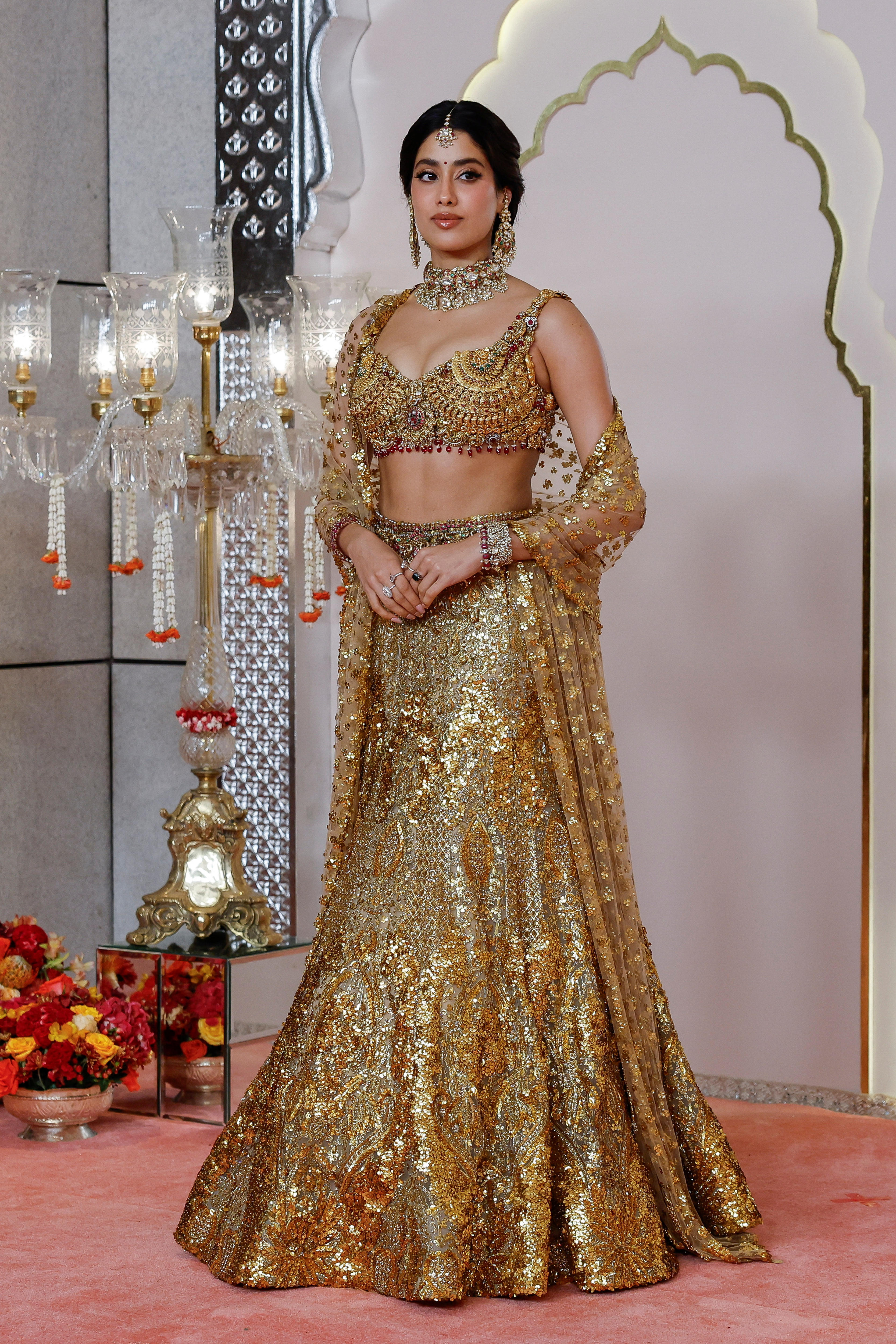 Janhvi Kapoor wearing an embellished metallic floor-length skirt with a matching crop top and shawl 