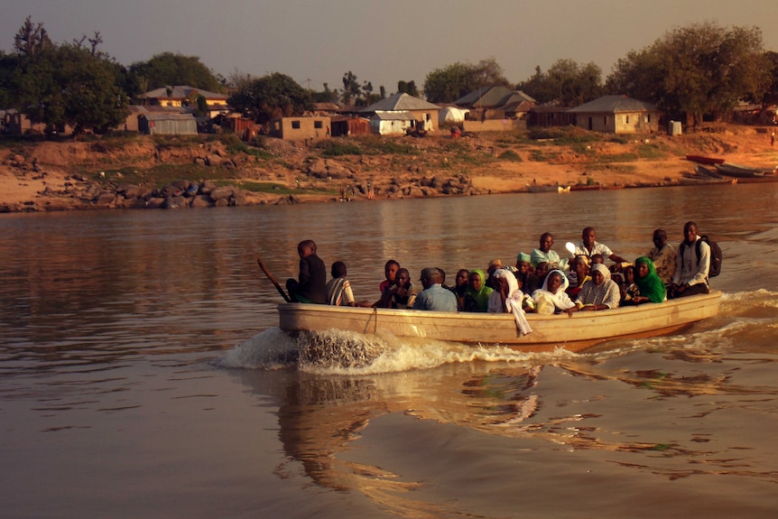 A full boat transporting people across river Niger
