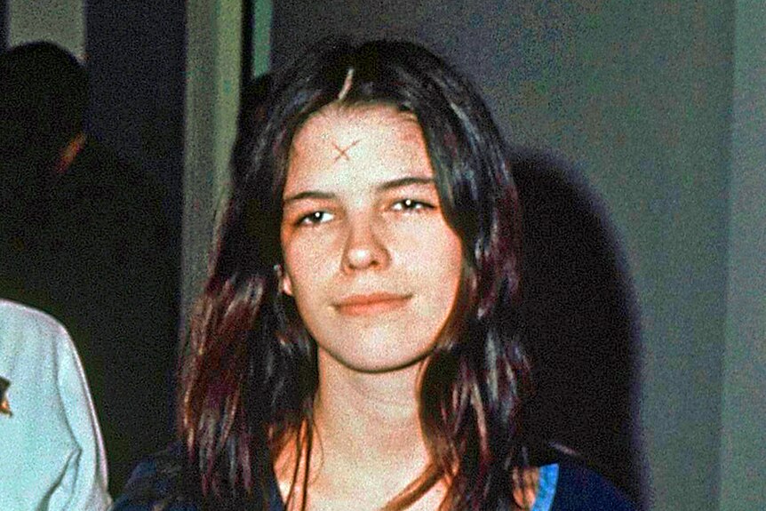 Leslie Van Houten in the 1970s with an X marked on her forehead 