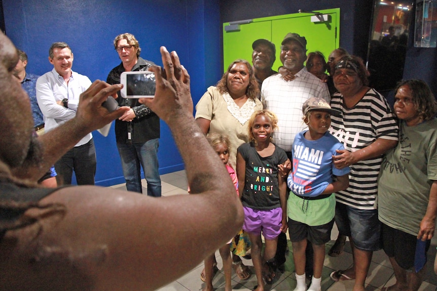 Sweet Country lead Hamilton Morris poses for photos with a large group of family members in the foyer of the cinema