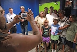 Sweet Country lead Hamilton Morris poses for photos with a large group of family members in the foyer of the cinema