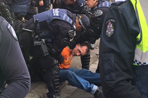 Police arrest a man during the clashes outside Milo Yiannopoulos's event.