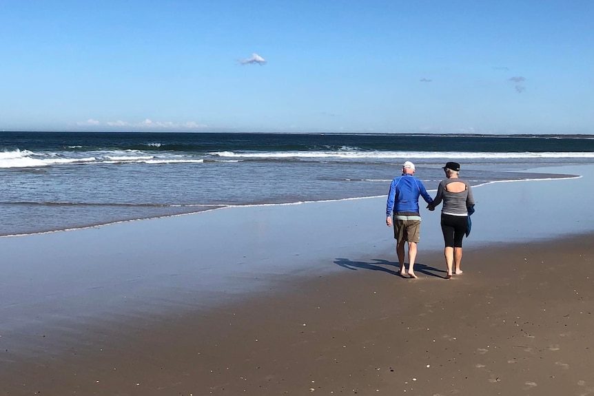 Roger and Ria Lukis walk along beach