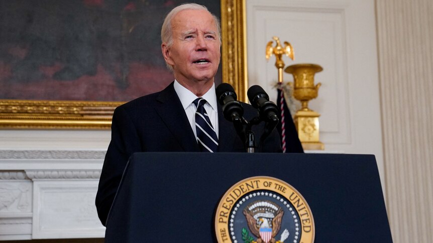 Joe Biden stands at lecturn