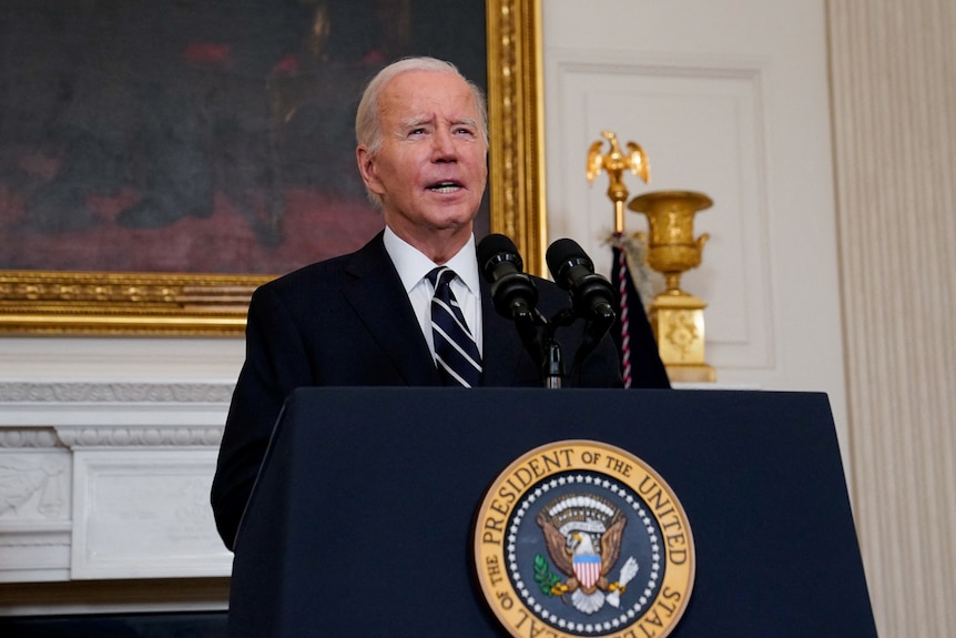 Joe Biden stands at lecturn