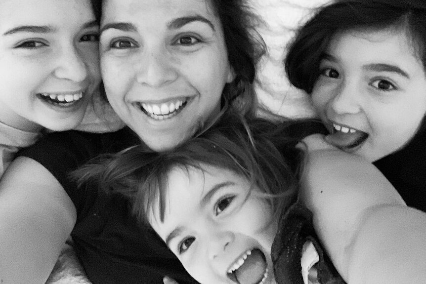 A selfie picture of a mum with her three daughters