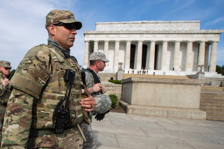 Members of the District of Columbia Army National Guard walk to their designated positions at the National Mall