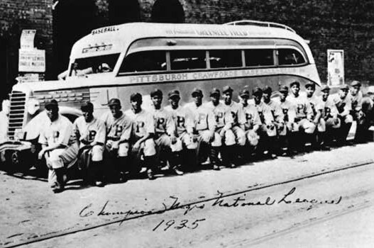 The Pittsburgh Crawfords line up for a photo next to the team bus in 1935.