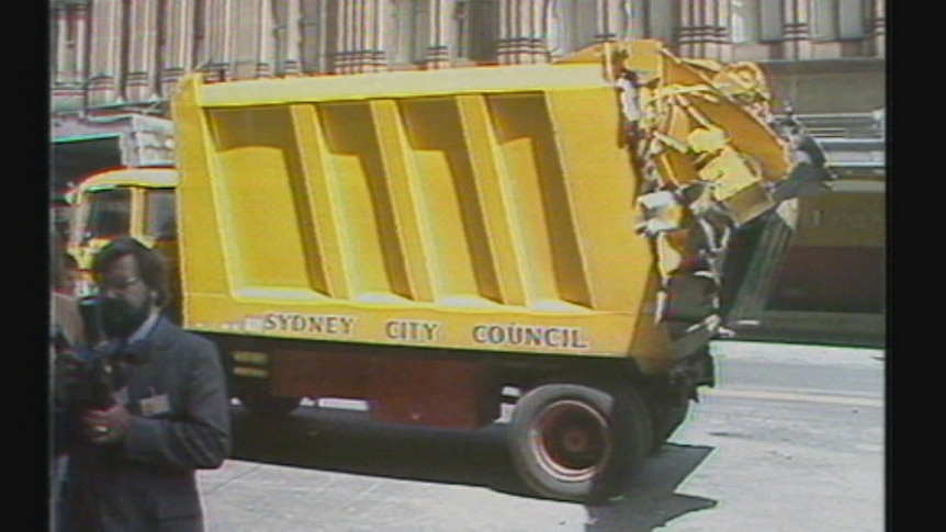 A large yellow rubbish truck.