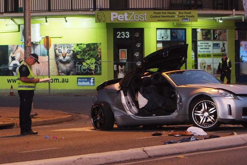 A damaged silver Nissan convertible car involved in a crash.