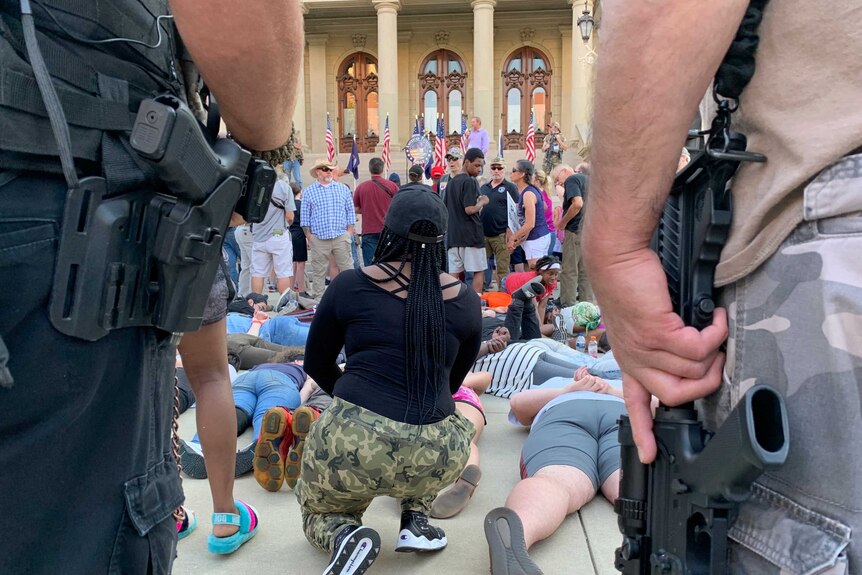 Counter-protesters lying on the ground.