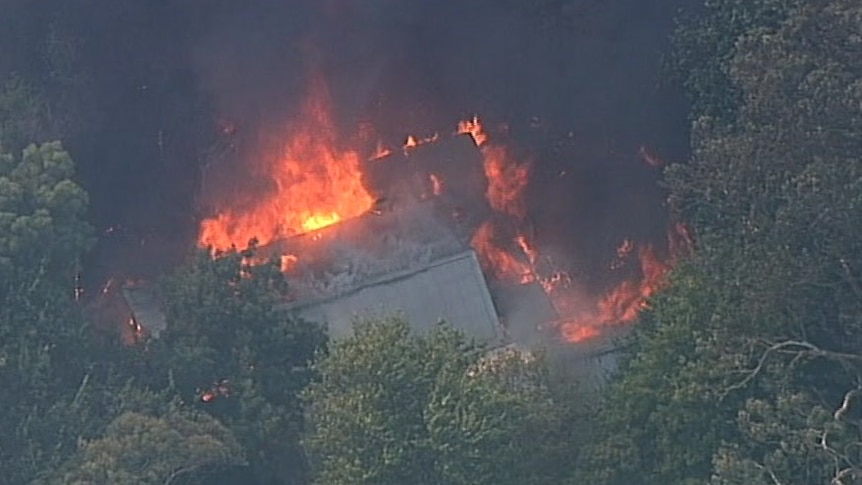 A house in flames from a helicpter in the Bunyip fire.