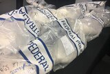 Close up of bags of ice at a police news conference.