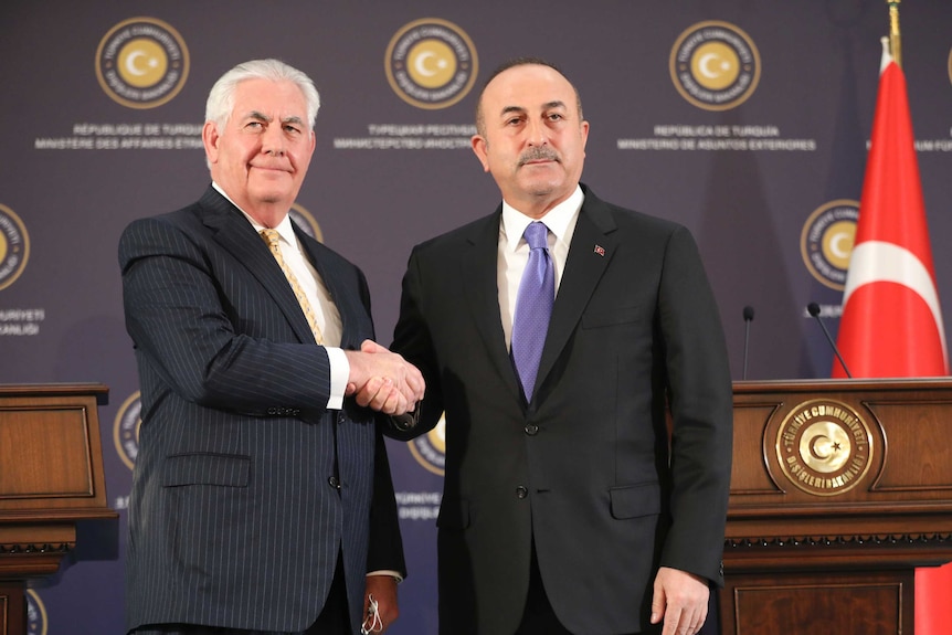 Turkey's Foreign Minister Mevlut Cavusoglu shakes hands with U.S. Secretary of State Rex Tillerson