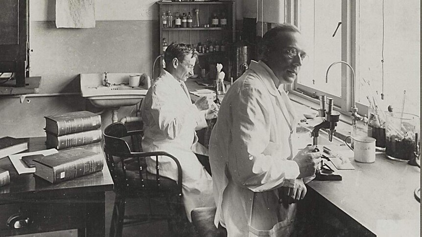 Black and white photo of scientists in a lab.
