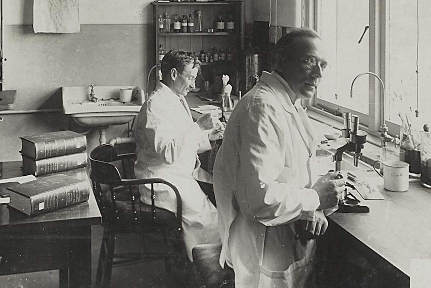 Black and white photo of scientists in a lab.