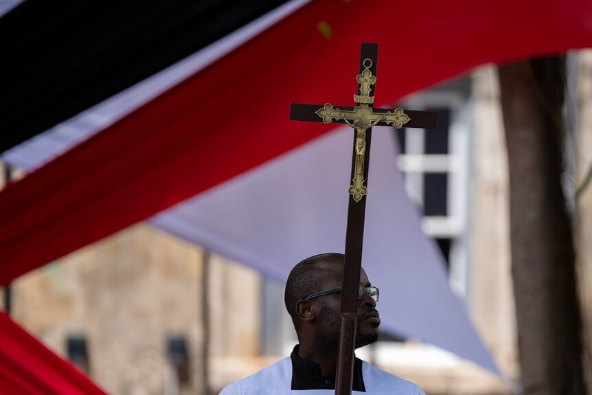 A man with a cross.