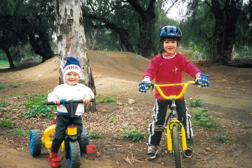 The Scotson brothers as children on their bikes.