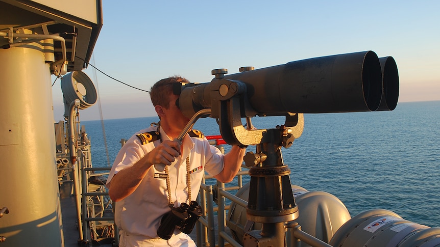 A sailor on duty at the HMAS Darwin Navy warship