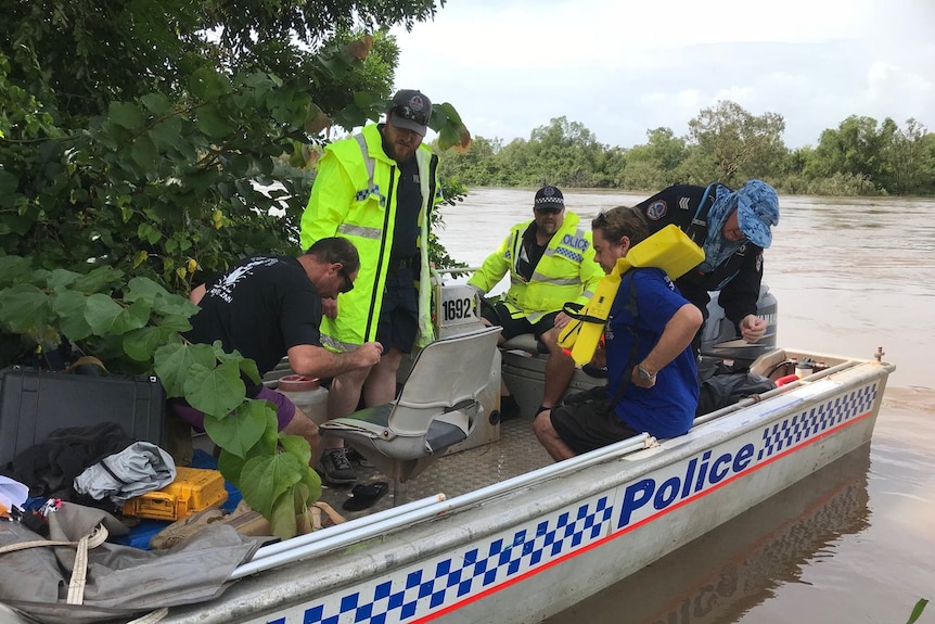 Police and members of the public aboard a police board on water.