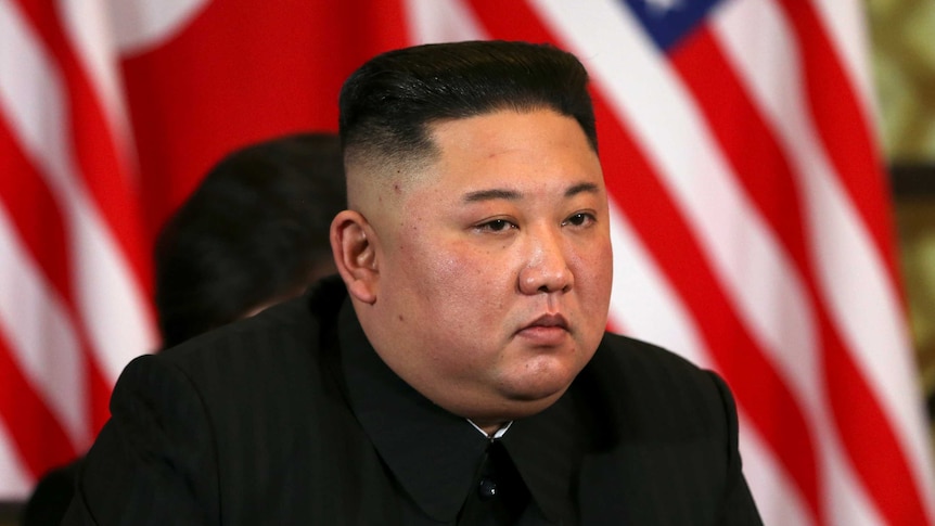 Kim Jong Un listens with an intense stare