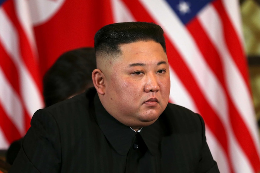 Kim Jong Un listens with an intense stare