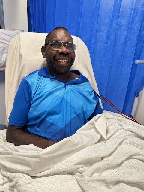 Dale Josiah sits on a hospital bed