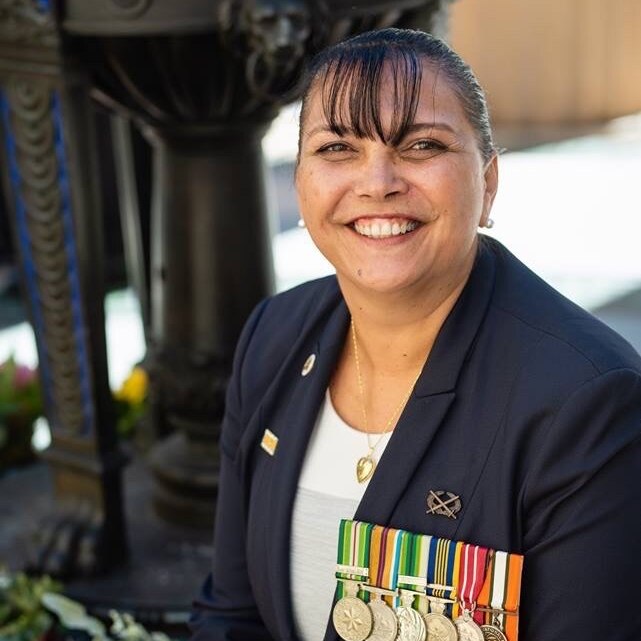 Lorraine Hatton, the Australian Army's Indigenous elder is smiling at the camera, wearing her medals