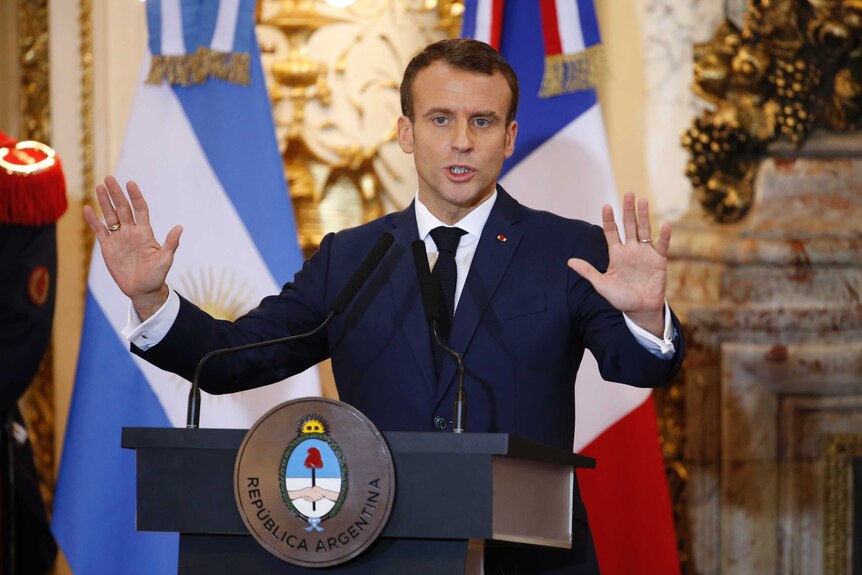 French president Emmanuel Macron speaks with his palms up ahead of G20 summit in Argentina