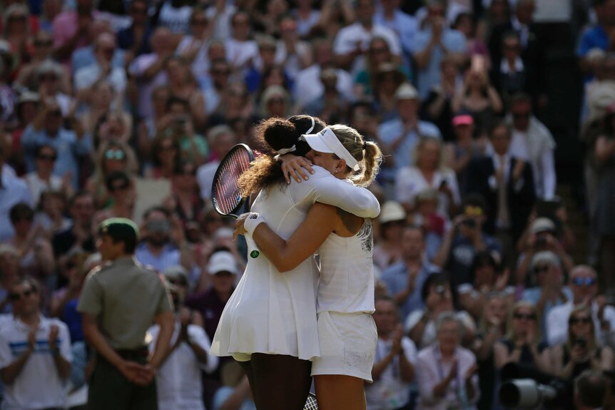 Angelique Kerber and Serena Williams hug on the court