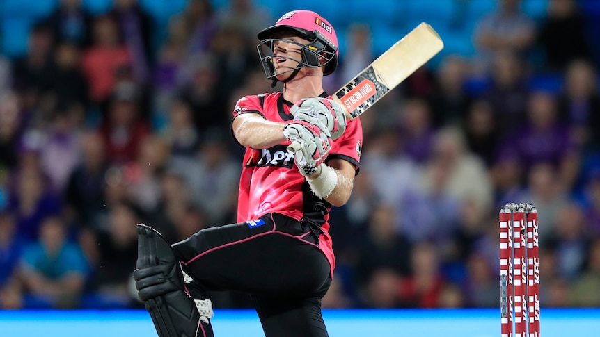 Sam Billings hits out while on one knee for the Sixers in their BBL clash with the Hurricanes in Hobart.