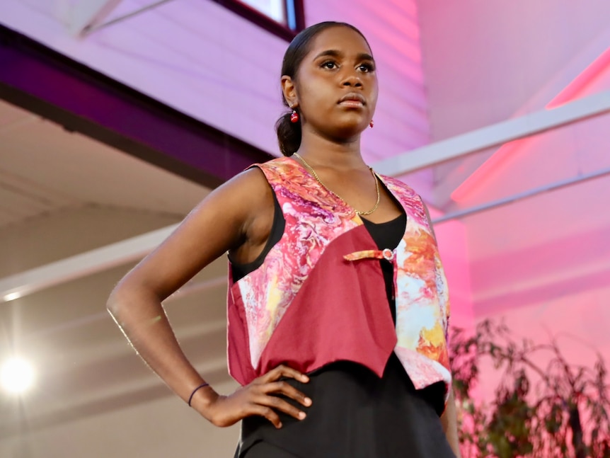 A young Indigenous model wears a colourful pink top.