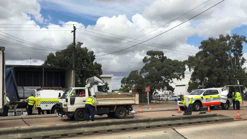 Police inspecting a truck on a sydney road.