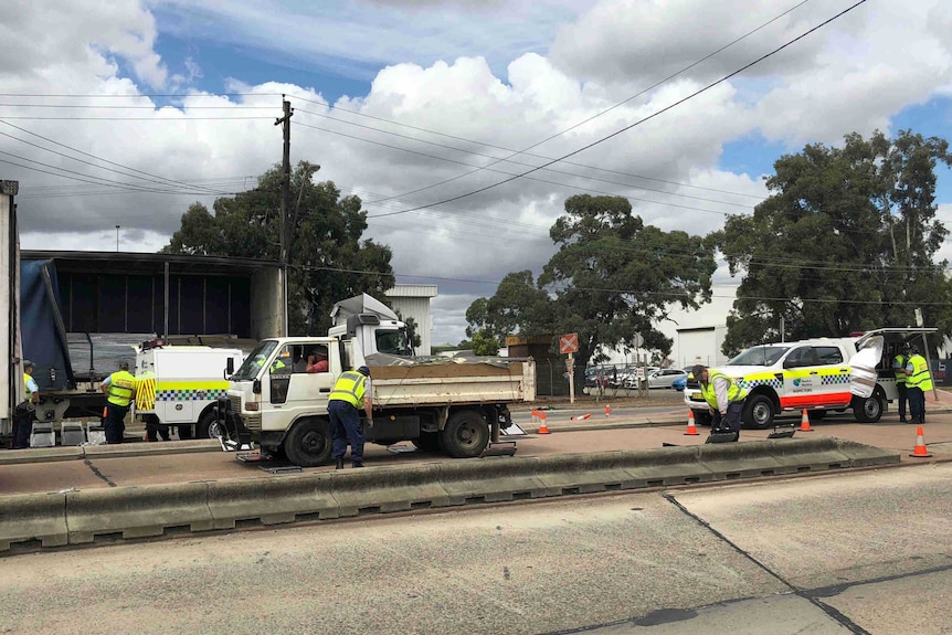 Police inspecting a truck on a sydney road.
