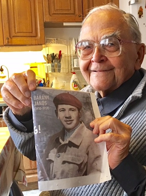 Imre Mecs holds a photo of a fellow freedom fighter who was executed in 1959.