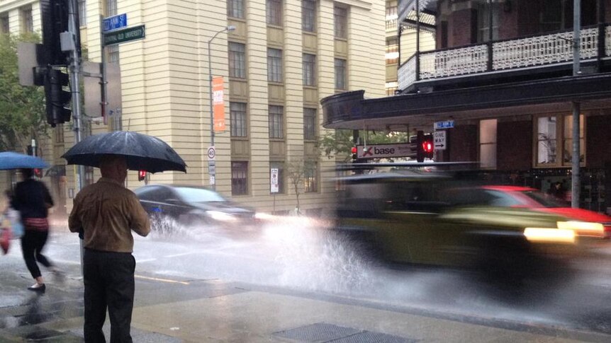 Car drives through wet Brisbane city