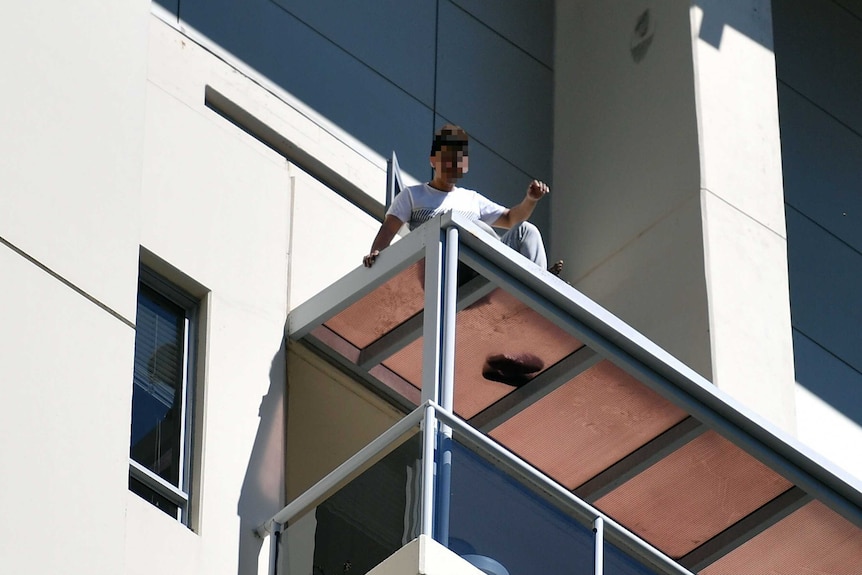 Man on apartment ledge in Chatswood