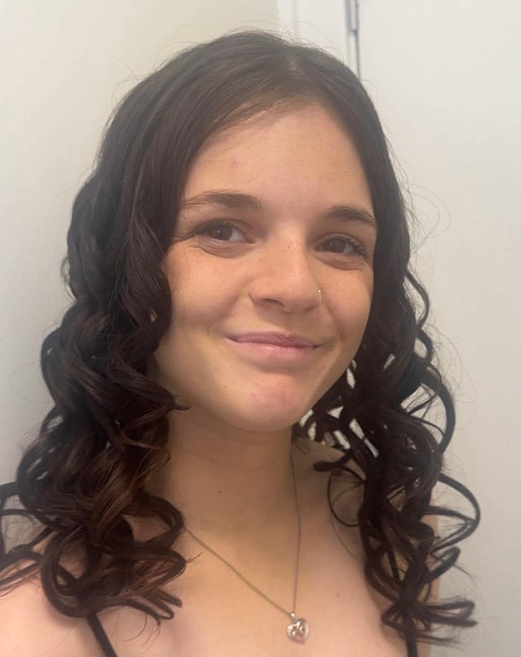 A headshot of a teenage girl, smiling