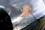 Chris Dawson is seen in a police car on arrival at Gold Coast airport, Thursday, December 6, 2018. 