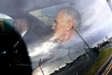 Chris Dawson is seen in a police car on arrival at Gold Coast airport, Thursday, December 6, 2018. 