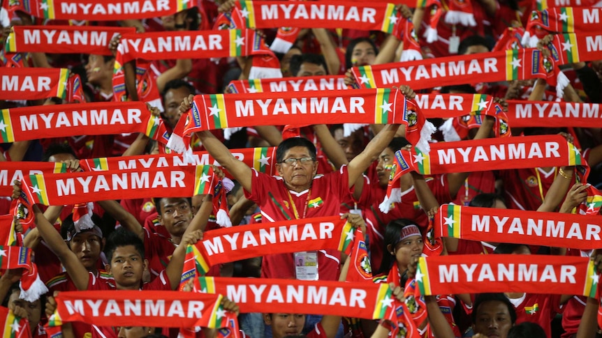 Myanmar supporters watch their football team take on Cambodia in Yangon, December 7, 2013