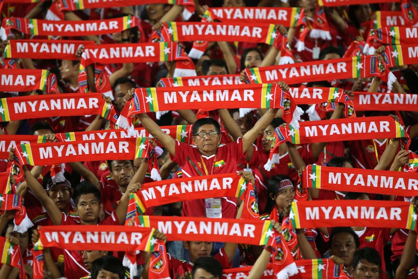 Myanmar supporters watch their football team take on Cambodia in Yangon, December 7, 2013